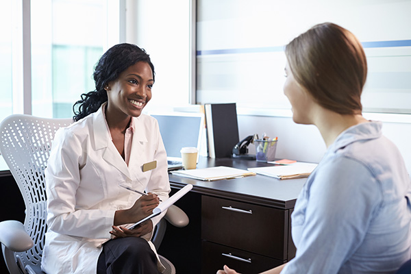 doctor-zimbabwe-health-insurance Doctor in Zimbabwe discussing health insurance with patient